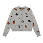 Adorable grey knit cardigan featuring a charming puppy print design. This cropped style offers a playful, contemporary look perfect for casual outings or layering. Crafted from soft, comfortable knit fabric that moves with you throughout the day. The cropped length pairs effortlessly with high-waisted bottoms for a modern silhouette. Ideal for animal lovers seeking a cozy yet stylish piece to add to their wardrobe.