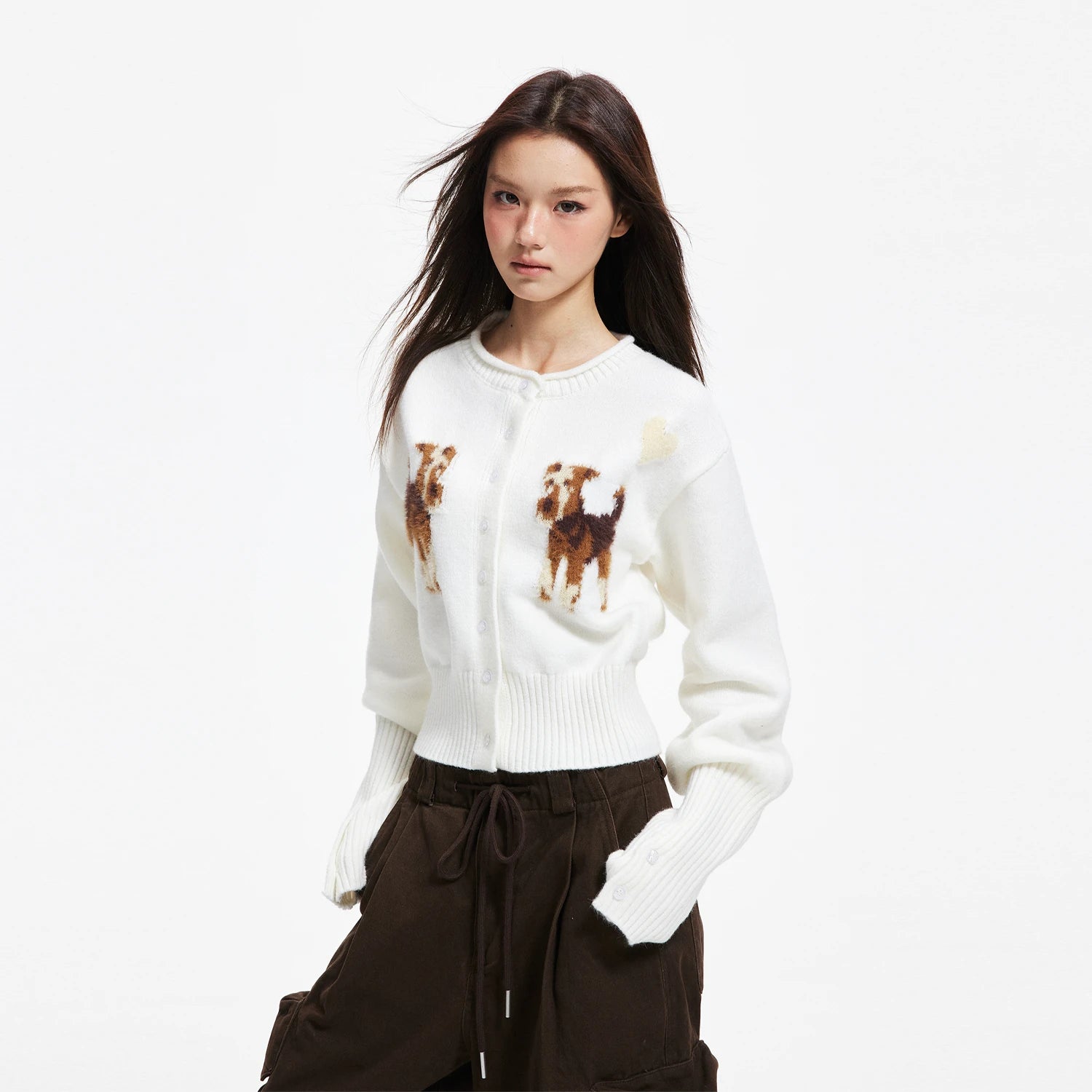 APEA's cozy puppy jacquard knit cardigan in a cropped, waist-cinching silhouette — an effortlessly chic layering piece for fall and winter.