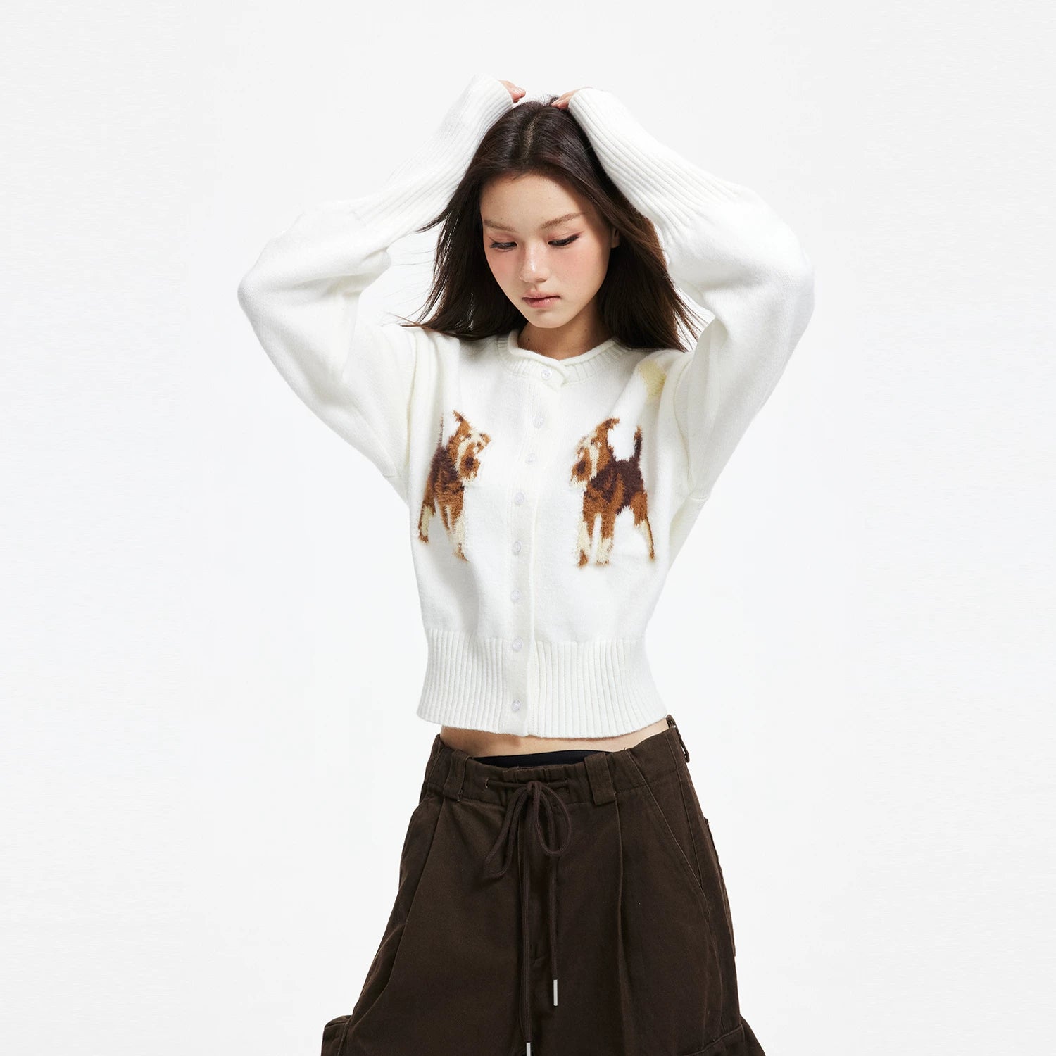 APEA's cozy puppy jacquard knit cardigan in a cropped, waist-cinching silhouette — an effortlessly chic layering piece for fall and winter.